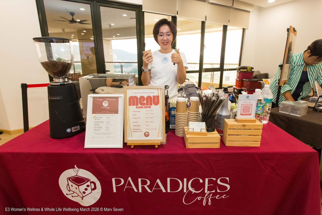 Paradices founder at the branded dark rose coffee bar with espresso grinder and menu