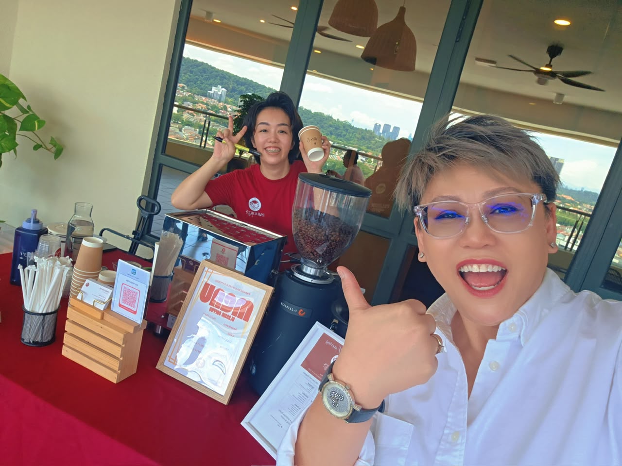 The Paradices team smiling behind the espresso machine at a networking event