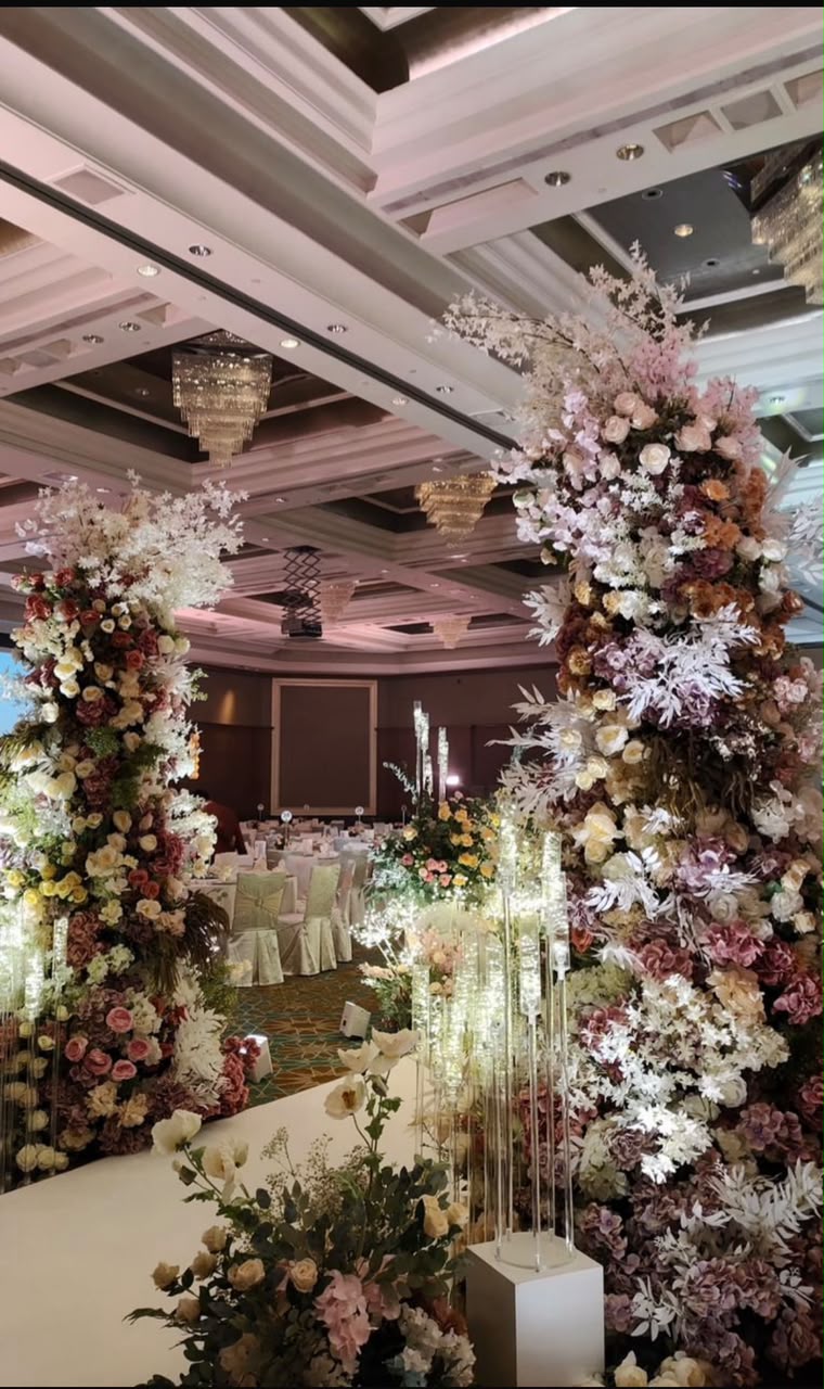 Tall floral pillars at the entrance of a wedding ballroom